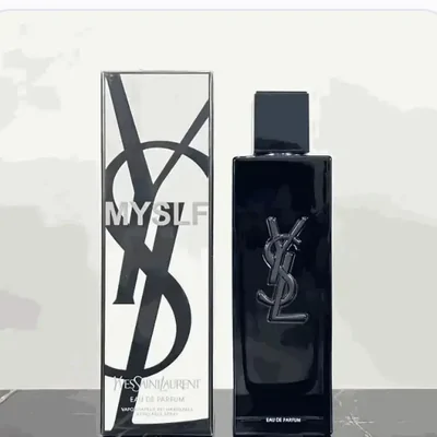 A tall glossy black fragrance bottle standing beside its printed outer carton on a white background, both carrying the same monogram